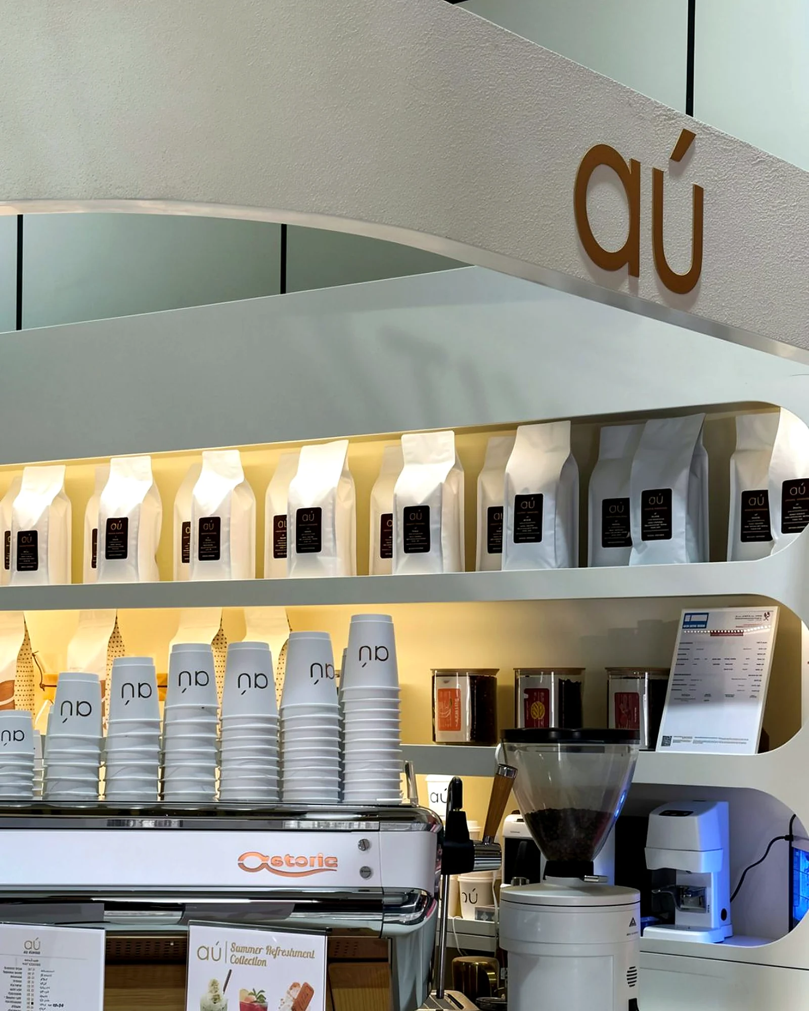 AU Gold Cafe counter with coffee equipment, cups and coffee bags