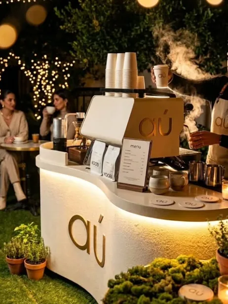 AU Gold Cafe mobile coffee bar glowing under warm evening lights